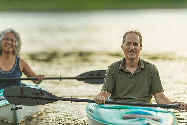 istock Older mature couple kayaking together during summer 639019992