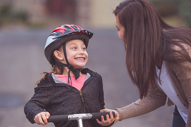 istock Ethnic mother putting a helmet on her daughter for 639020068