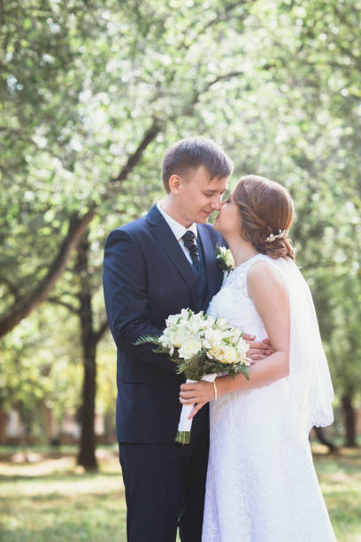 istock couple bride and groom on a park background 639022016