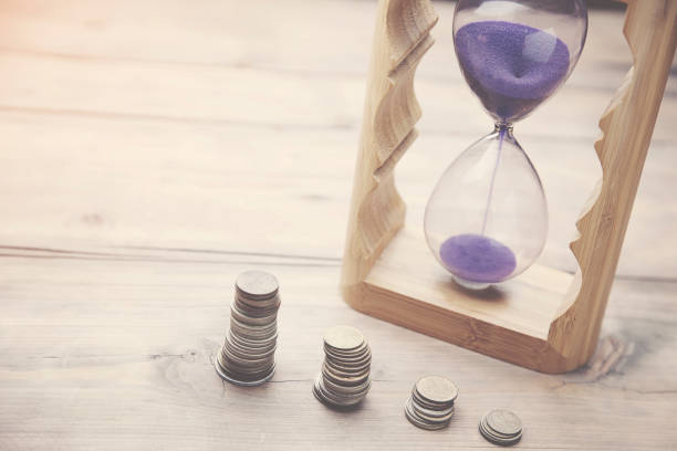 istock Hourglass with coins 639022560