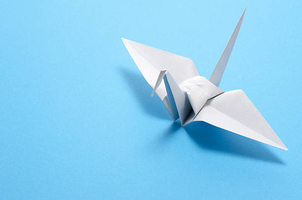 istock origami crane on blue background 639022612