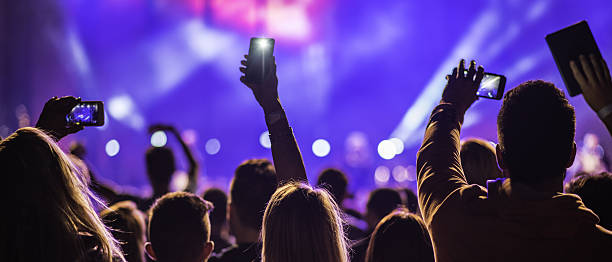 People filming a concert