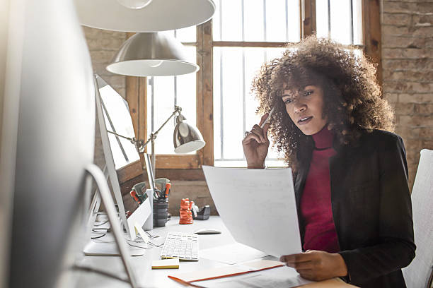 istock Businesswoman reading document in creative office 639024570
