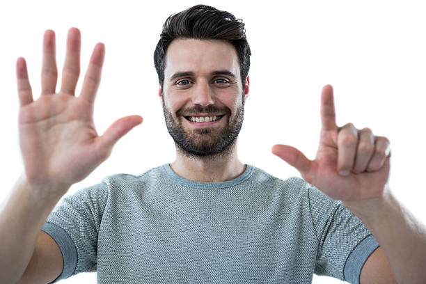 istock Smiling man pretending to touch an invisible screen 639025338