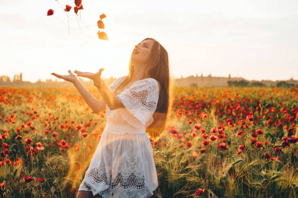 istock woman in poppy field 639026160