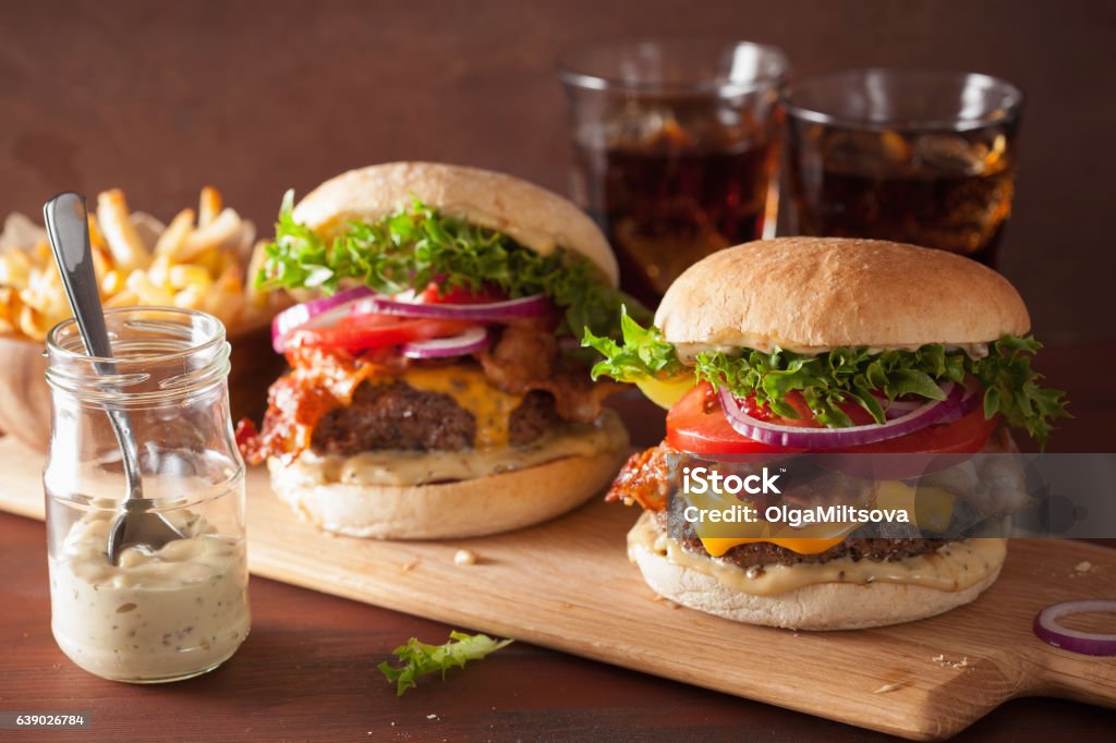 bacon cheese burger with beef patty tomato onion Burger Stock Photo