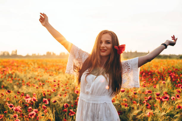 istock woman in poppy field 639026880