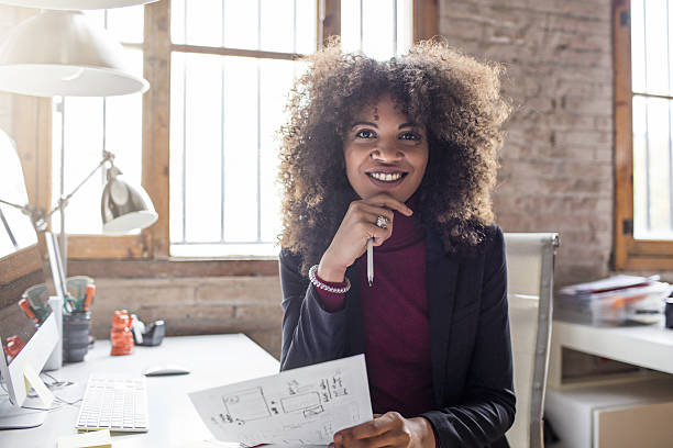 istock Happy businesswoman holding document at desk 639027094