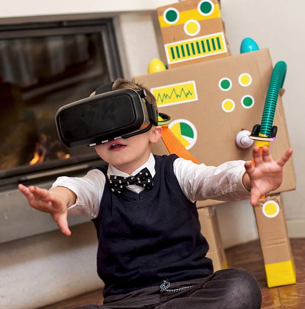 istock Child Playing with Augmented Reality Eyeglasses and Toy Robot 639027244