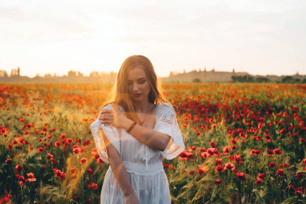 istock woman in poppy field 639027300