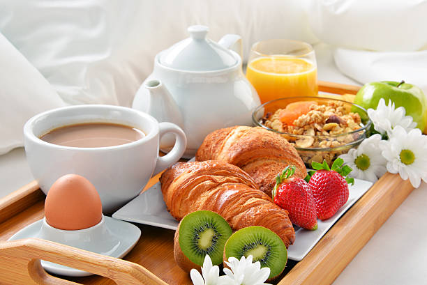 istock Breakfast tray in bed in hotel room 639027588
