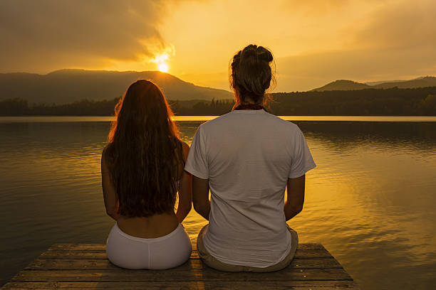istock Couple looking at the sunset over lake 639028078