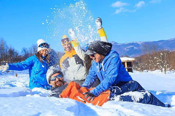 istock Group of friends lying down and enjoying the snow 639028482
