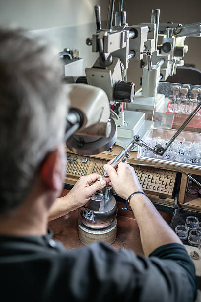 istock Professional gemstone settings jewellery craft laboratory: Man working with microscope 639029950