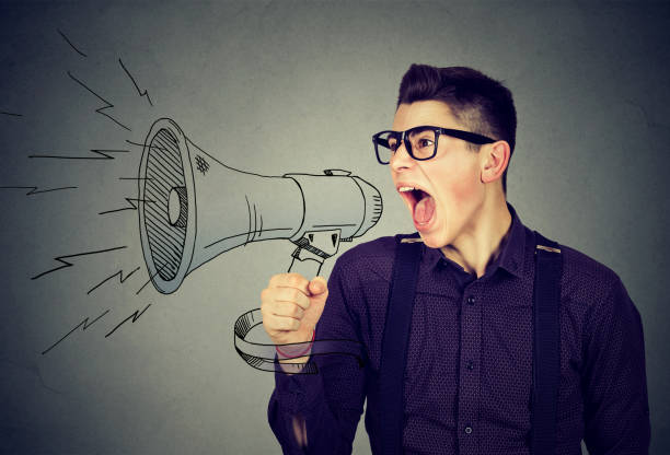 istock Angry young man screaming in megaphone 639029960