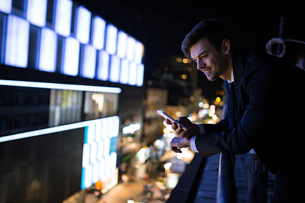 istock Businessman enjoying social networking on mobile phone 639030262