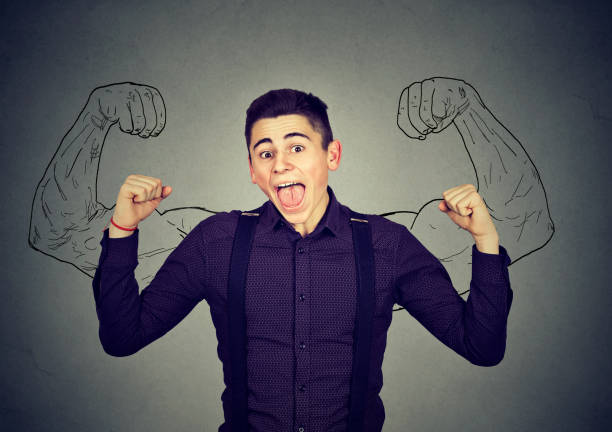 istock Successful man pumping fist celebrating success flexing muscles 639030572