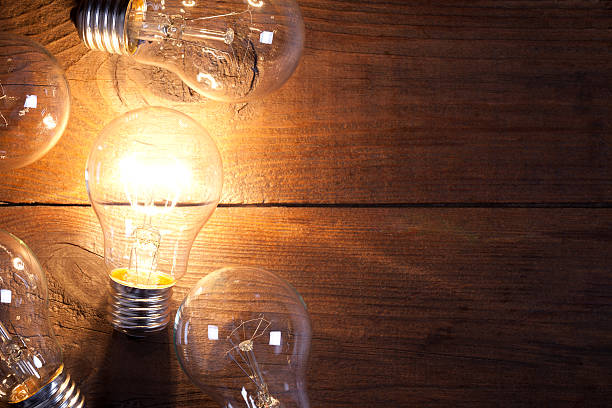 istock Vintage incandescent bulbs on old wooden table 639031054