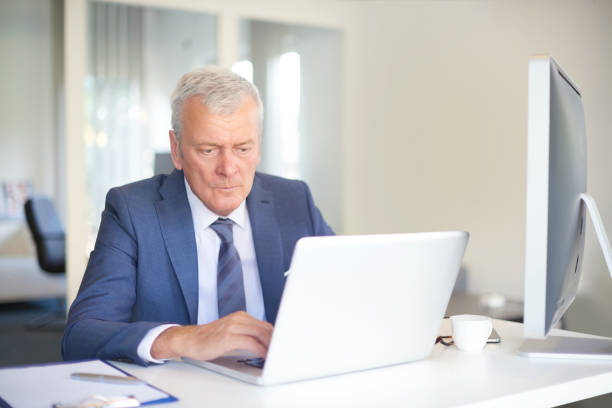 istock Senior businessman working online 639031128