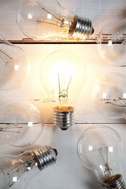 istock Vintage incandescent bulbs on white wooden table 639031158