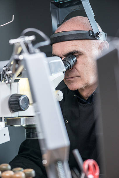 istock Professional gemstone settings jewellery craft laboratory: Man working with microscope 639032256