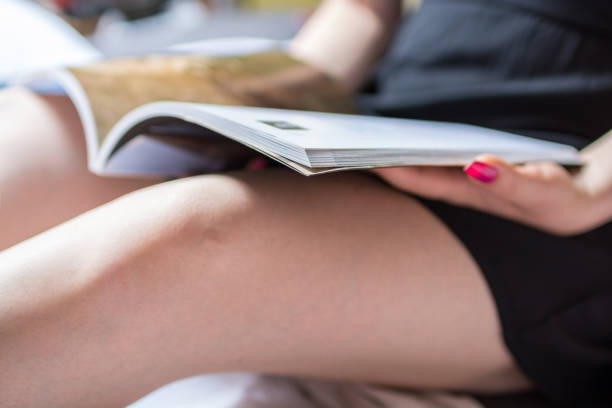 istock Young woman holding an open book 639032402
