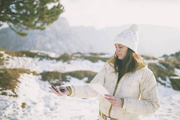 istock Woman hiker reading map in mountains on hiking trip. 639033676