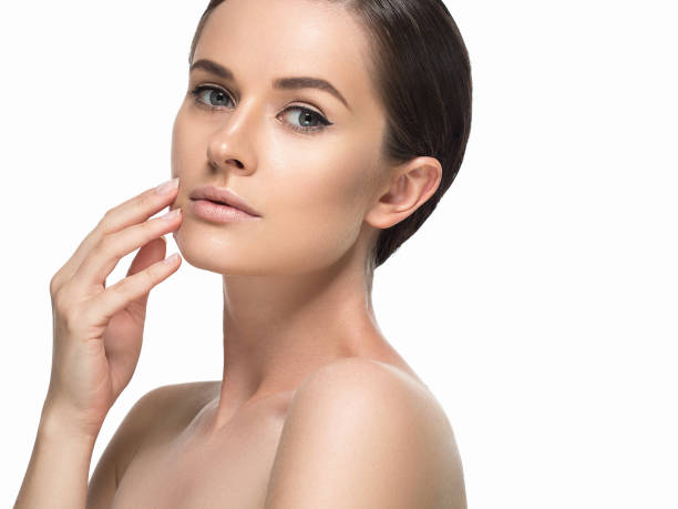 istock Young beautiful woman face portrait  touching her face. Studio shot. 639034610