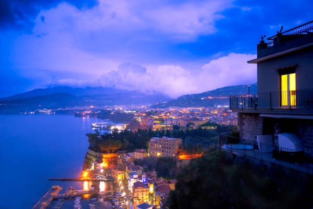 Beautiful night view of Italy's Amalfi coast lit up at night from Sorrento towards Naples.