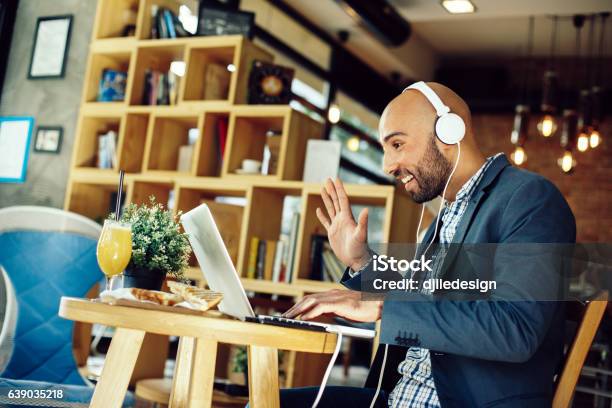 Businessman In A Cafe At Breakfast Making Video Call Stock Photo - Download Image Now