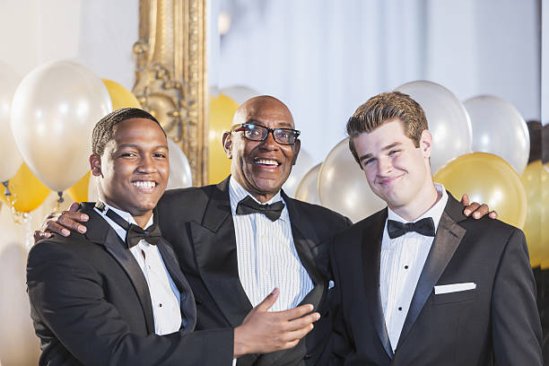 istock Senior black man wearing tuxedo with two young men 639039592