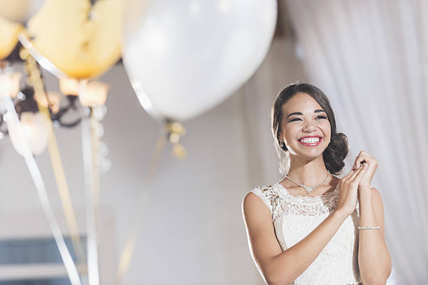 young mixed race woman in white dress at party - personal accessory balloon beauty birthday imagens e fotografias de stock