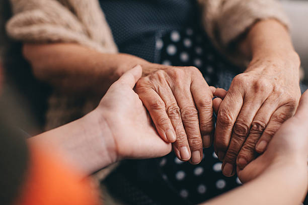 mi piace. - holding hands human hand senior adult consoling foto e immagini stock