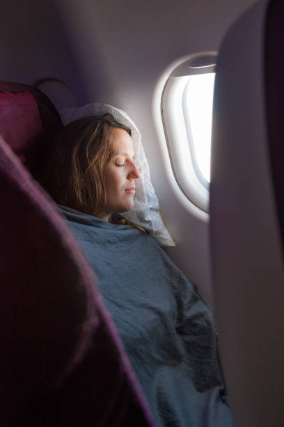 istock Female passenger sleeping covered with blanket. 639040884