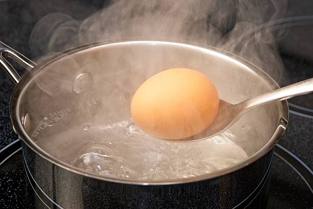 istock Boiling breakfast eggs in a steaming pot of water. 639042732