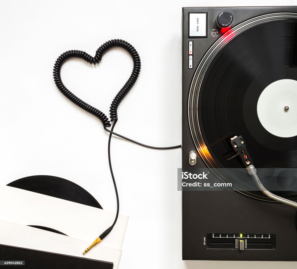 Romantic Music Concept, Turntable, Vinyl and Cord Shaped of Heart Professional Turntable, Vinyl Record Playing, Headphones with cord Shaped of Heart. Heart Shape Stock Photo