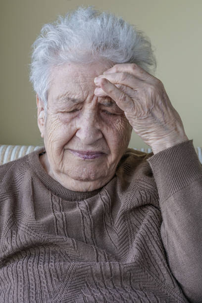 istock ill senior woman has headache 639042862