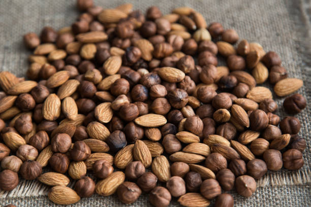 istock scattering a pile of nuts on burlap cloth 639043184