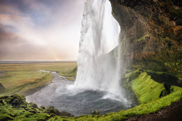 istock Seljalandsfoss, Iceland - Passage under the waterfall with rainb 639045906