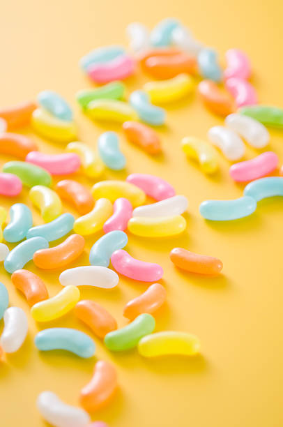 istock Colourful jelly beans on yellow background 639052602