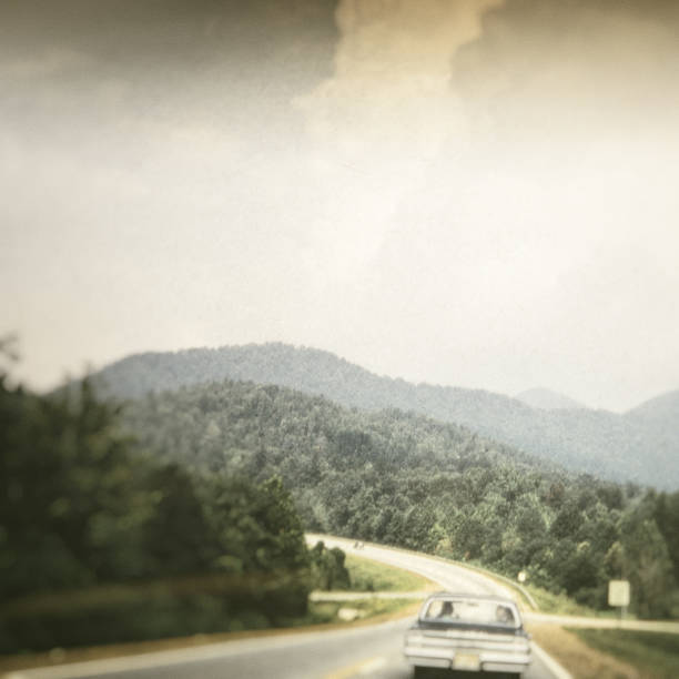 Cars driving on a winding mountain highway.