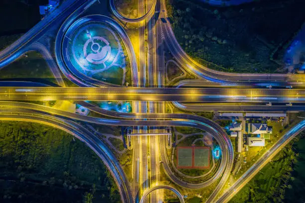 Aerial view Road roundabout with car lots in Thailand.street large beautiful downtown at night.cityscape.Top view.