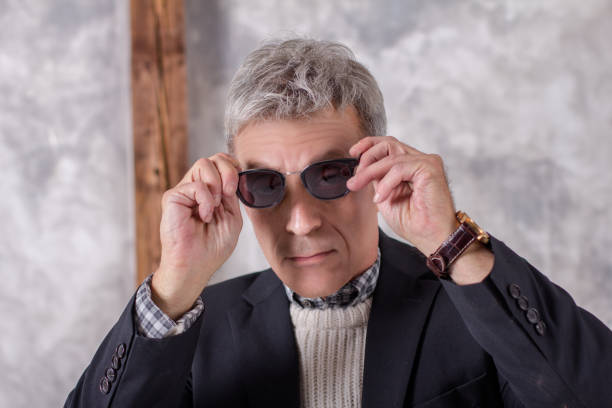 Portrait of a man in black jacket dresses glasses stock photo