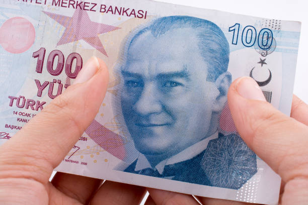 istock Hand holding 100 Turksh Lira banknotes  in hand 639057020