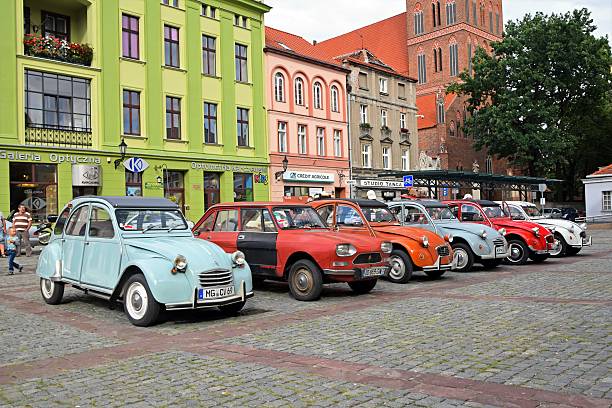 classic citroen vehicles parked on the street - deux chevaux stockfoto's en -beelden