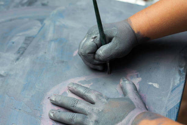 istock Childs painted hand over a painted wood surface 639059694