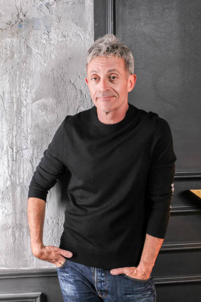 istock Man standing in a studio in black shirt middle age 639061068