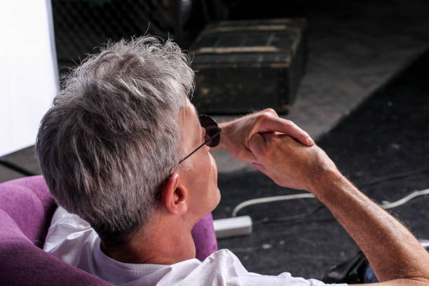man with glasses looking thoughtful rear view stock photo