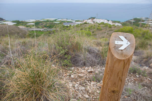Hiking sign at trekking path beside the coast Hiking sign at trekking path over Nerja Caves Mountain. Overlooking Town of Nerja, Malaga, Spain almijara stock pictures, royalty-free photos & images