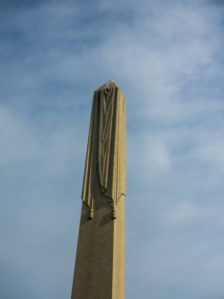 istock Cemetery Obelisk against a Blue and Cloudy Sky 639067576